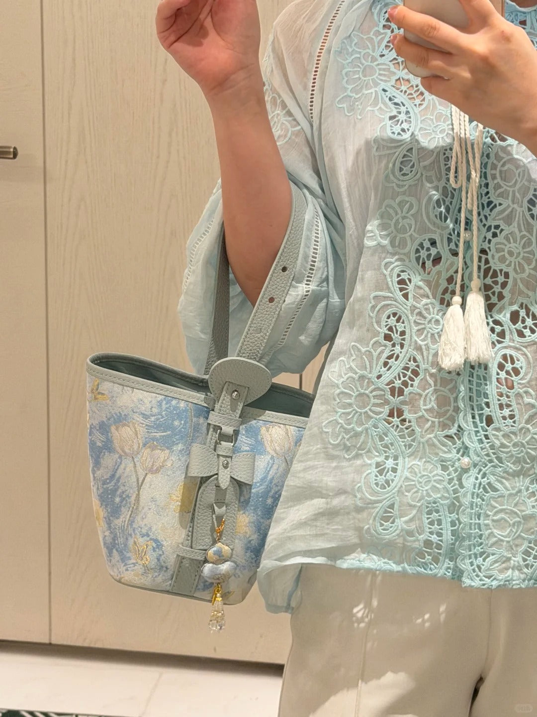 Close view of Song brocade bucket bag showing woven motif texture and refined image row 458