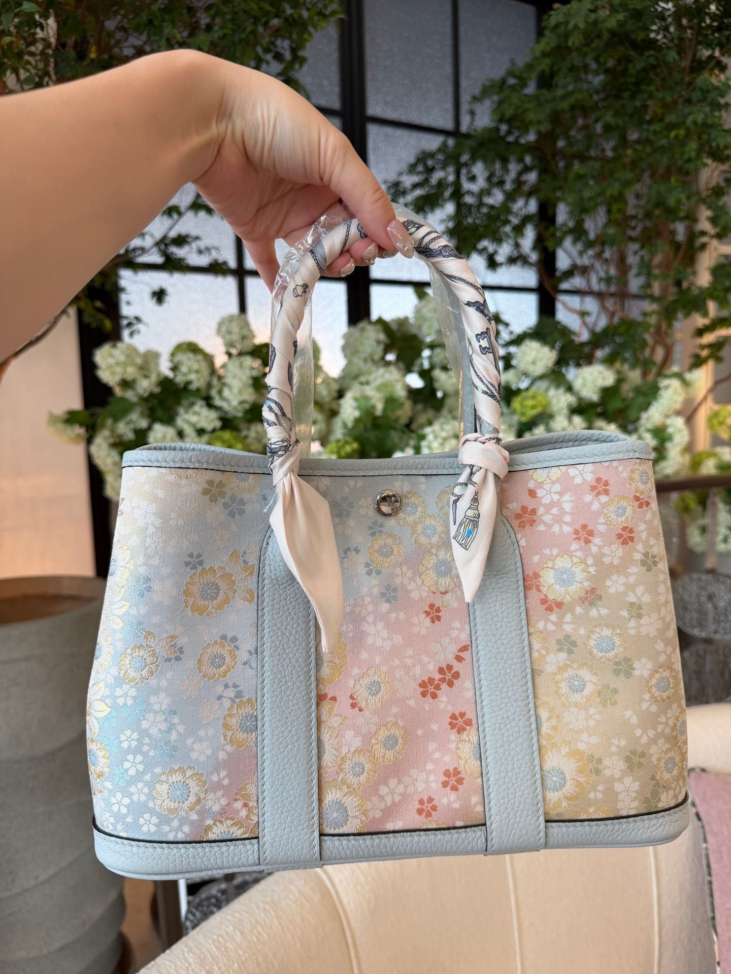 Close view of mulberry silk clutch bag showing woven motif texture and refined finish featuring Song Brocade Garden Tote