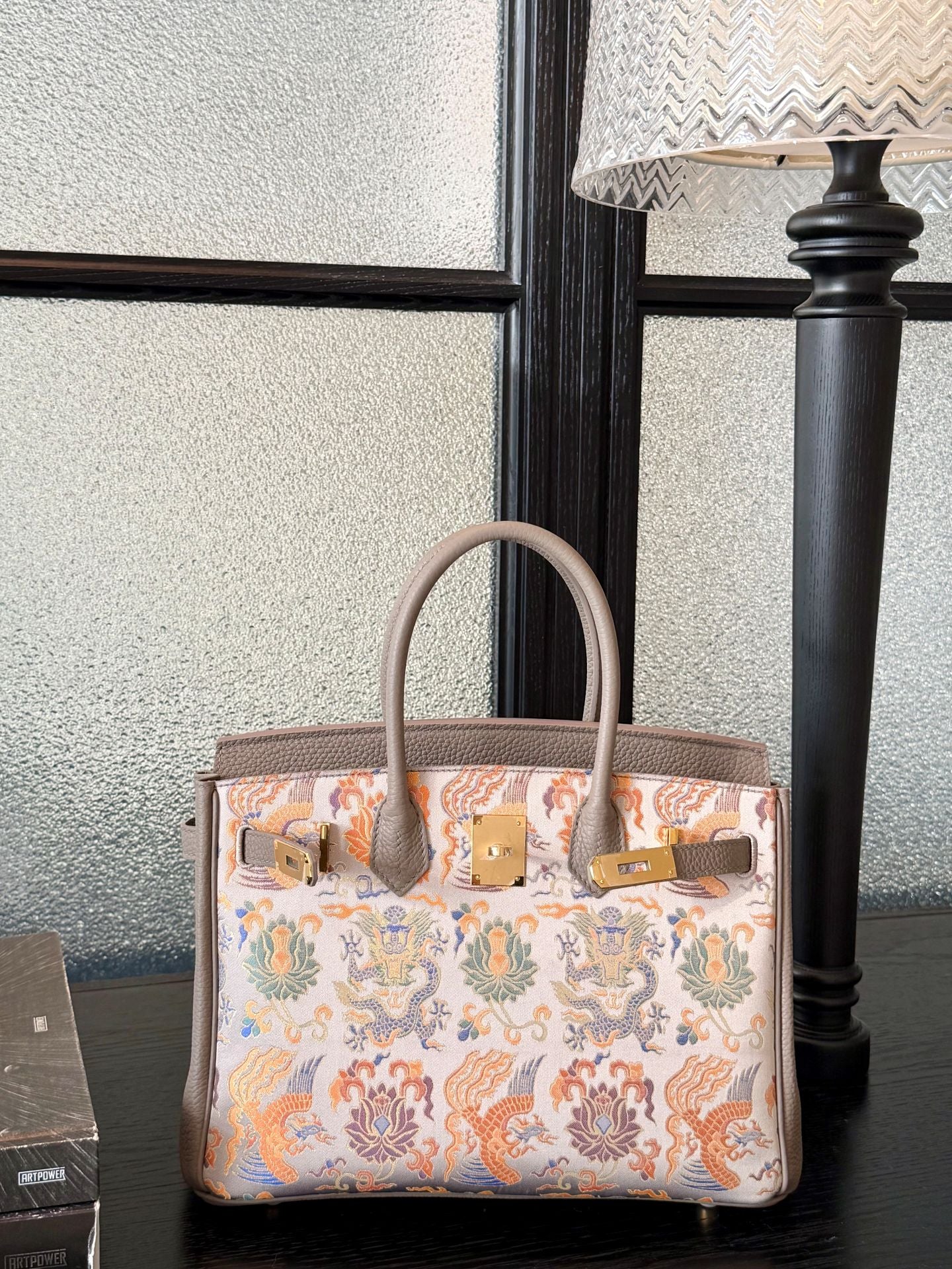 Close view of Song brocade Kelly bag showing woven motif texture and refined finish featuring Grey Dragon & Phoenix