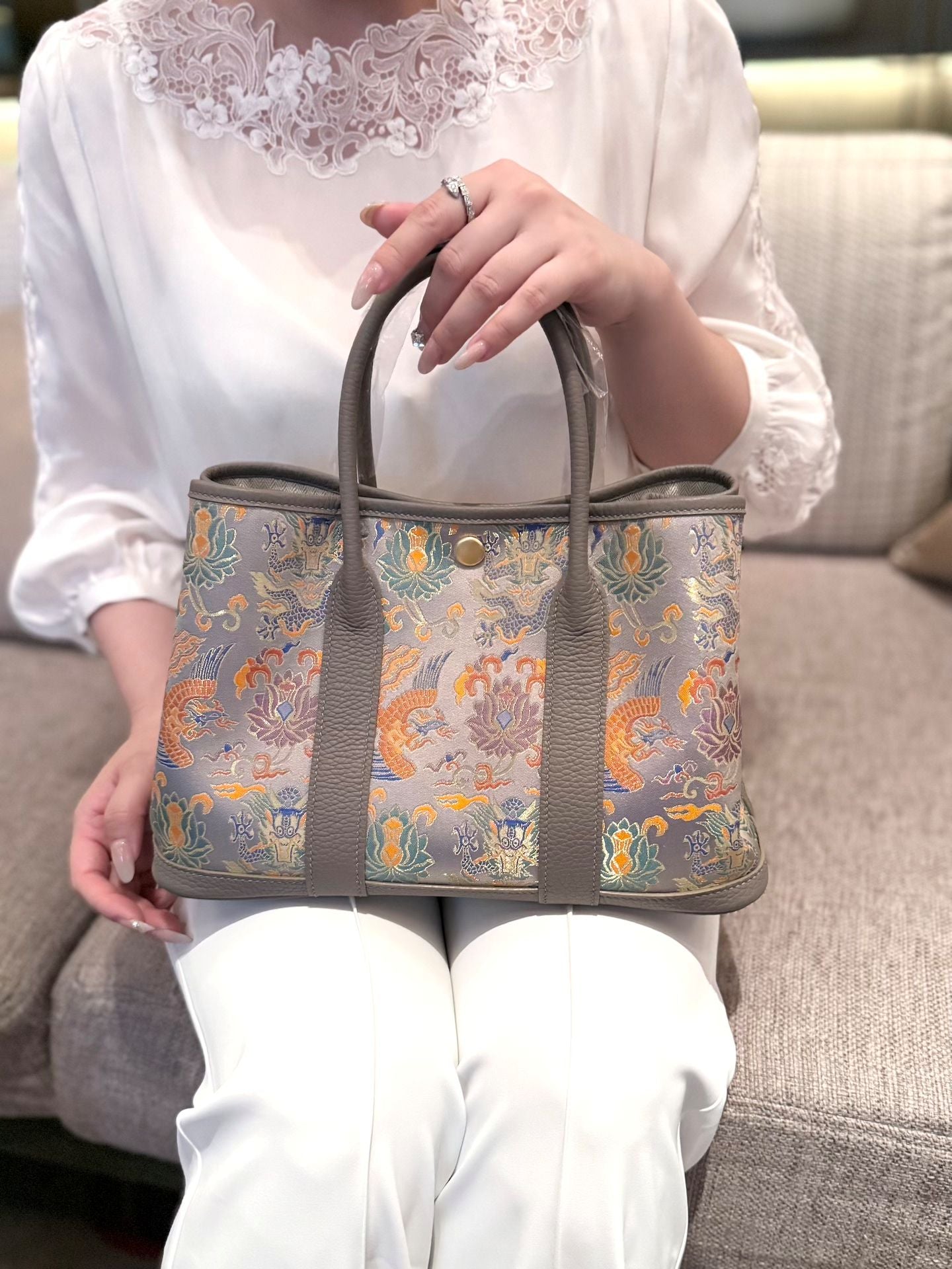 Close view of mulberry silk clutch bag showing woven motif texture and refined image row 512