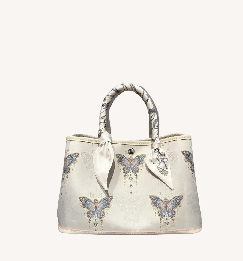 Mulberry silk clutch bag with butterfly motif and structured elegant handbag silhouette