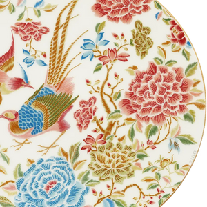Detailed view of floral and bird design on bone china dinner plate.