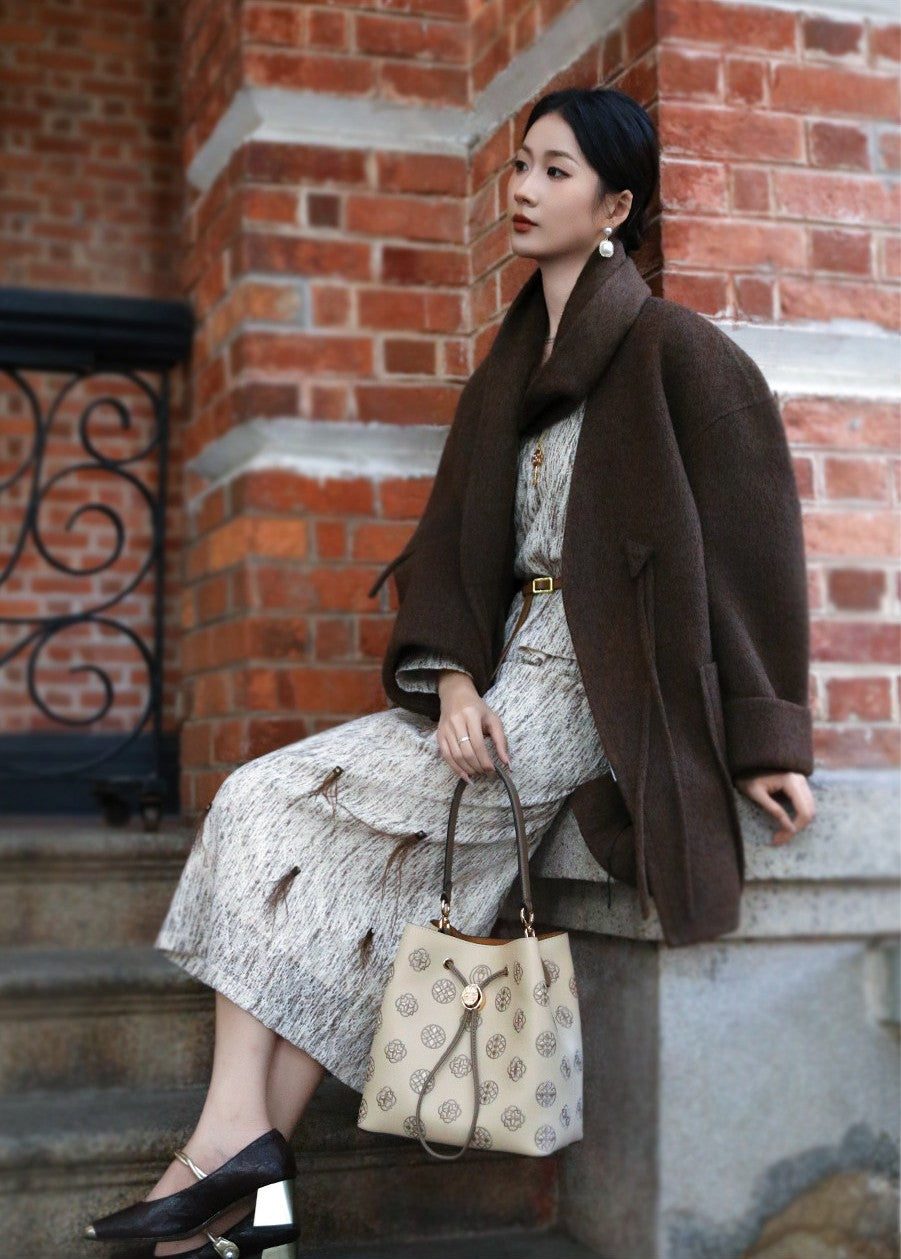 Close view of embroidered bucket bag showing floral texture and refined leather finish featuring Vintage Shoulder & Handbag