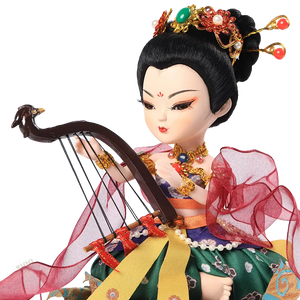 Left upper body detail of 9-inch Dunhuang "Harp Melody" doll showing arm, bracelet, and necklace.
