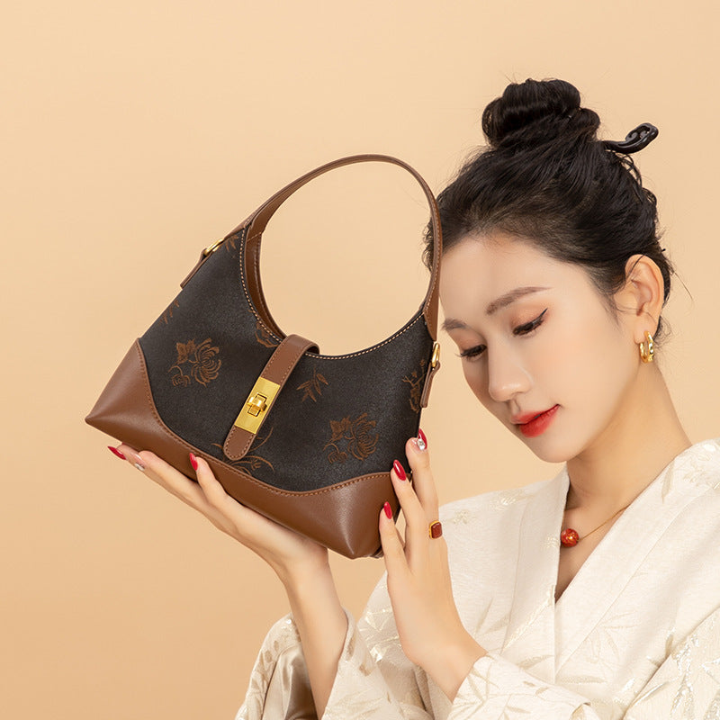 Crossbody bag detail with refined hardware, protective studs, and silk textile finish featuring Xiangyunsha Heritage New