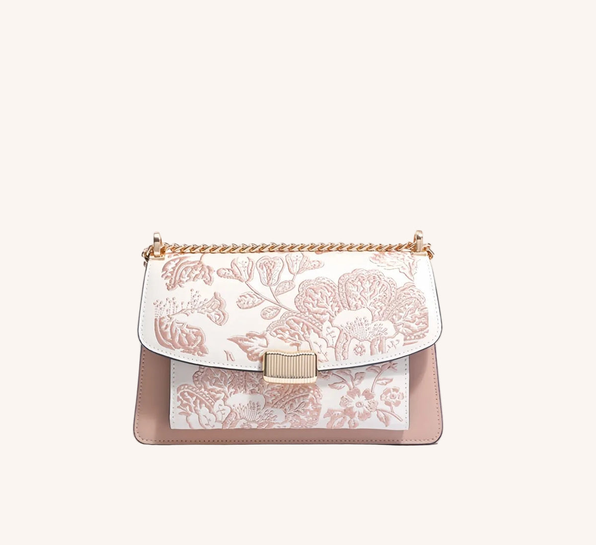 Close view of embroidered shoulder bag showing floral texture and refined leather finish