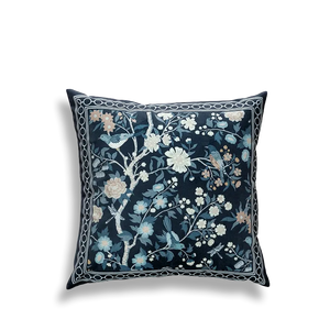 Blue embroidered pillow featuring full floral and bird scene.