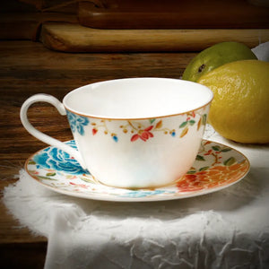 Bone china cup and saucer with fresh pear on linen cloth.