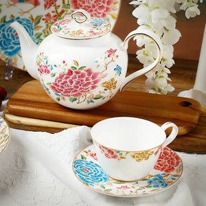 Angled view of floral tea set onAngled view of floral tea set on wooden display board.