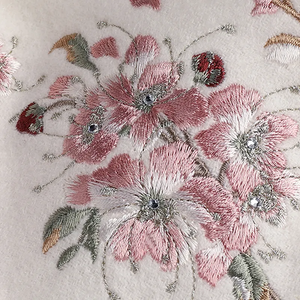 Hand-stitched camellia flower embroidery on cashmere scarf.