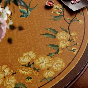 Close-up overhead: floral swallow pattern detail on round table mat.