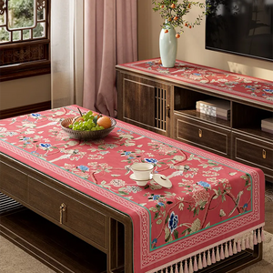 Vintage floral tablecloth draped diagonally on table.