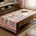 Pastel pink vintage floral tablecloth on table.