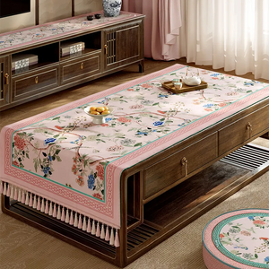 Pastel pink vintage floral tablecloth on table.