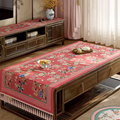 Pastel red Chinoiserie vintage tablecloth on table.