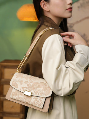 Close view of embroidered crossbody bag showing floral texture and refined leather finish featuring Chinese Style Begonia-brocademodern