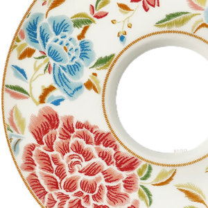Close-up of Qing-inspired floral relief on saucer's left side.