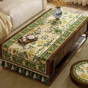 Green vintage tablecloth fully covering
 table.