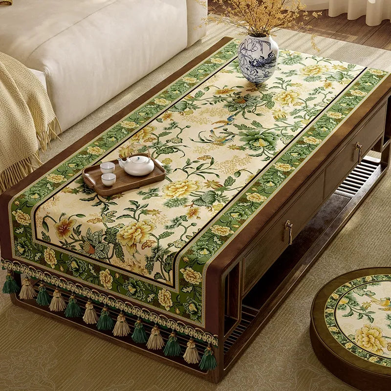 Green vintage tablecloth fully covering
 table.
