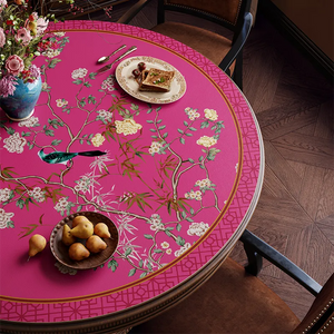 Pink retro floral bird table mat detail with pastries, top view.