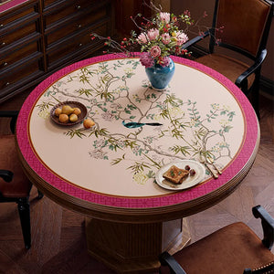 Pink chinoiserie table mat with light center, top view.