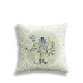 White embroidered pillow with circular birds and flowers.