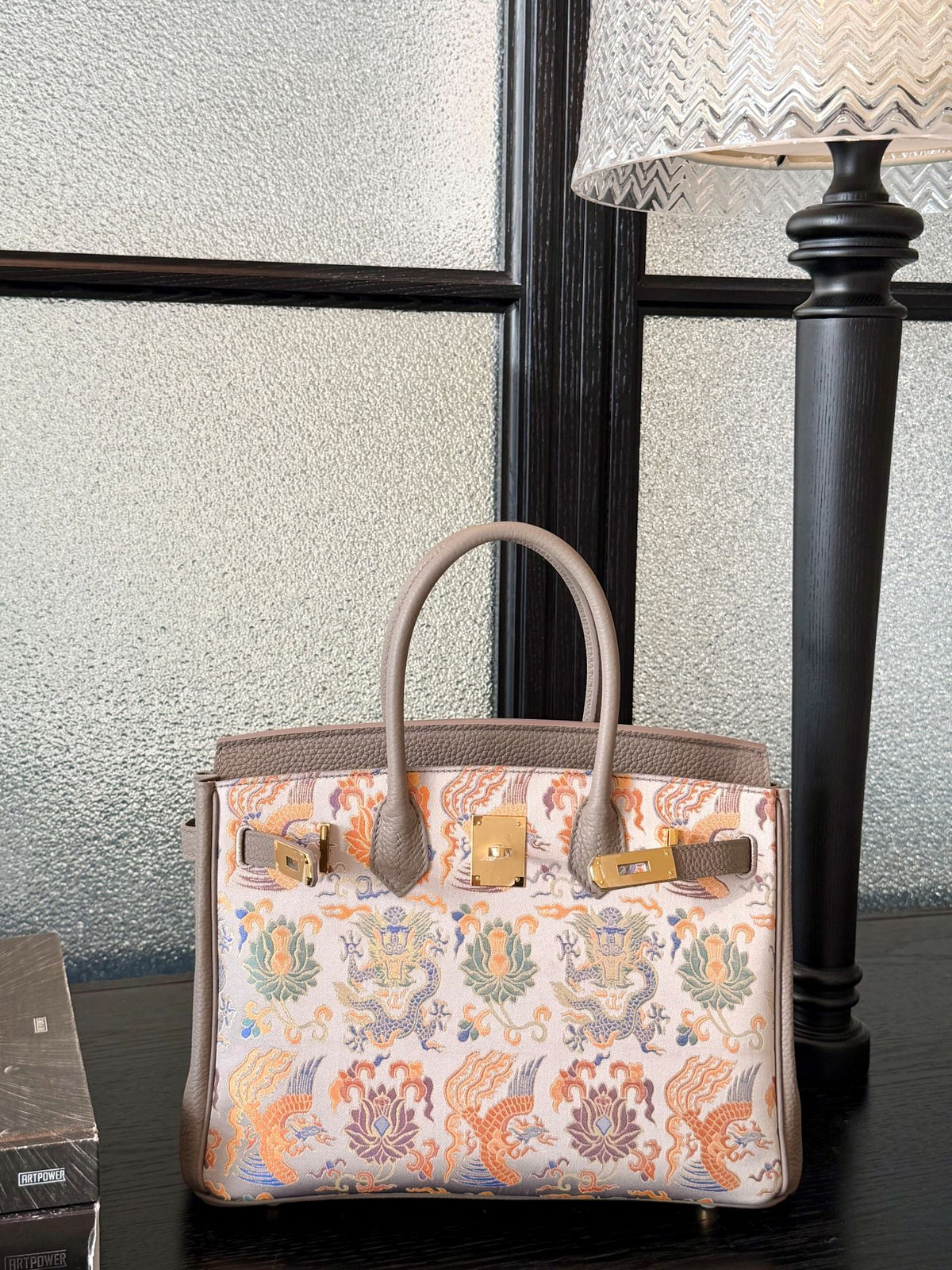 Close view of Song brocade Kelly bag showing woven motif texture and refined finish featuring Grey Dragon & Phoenix