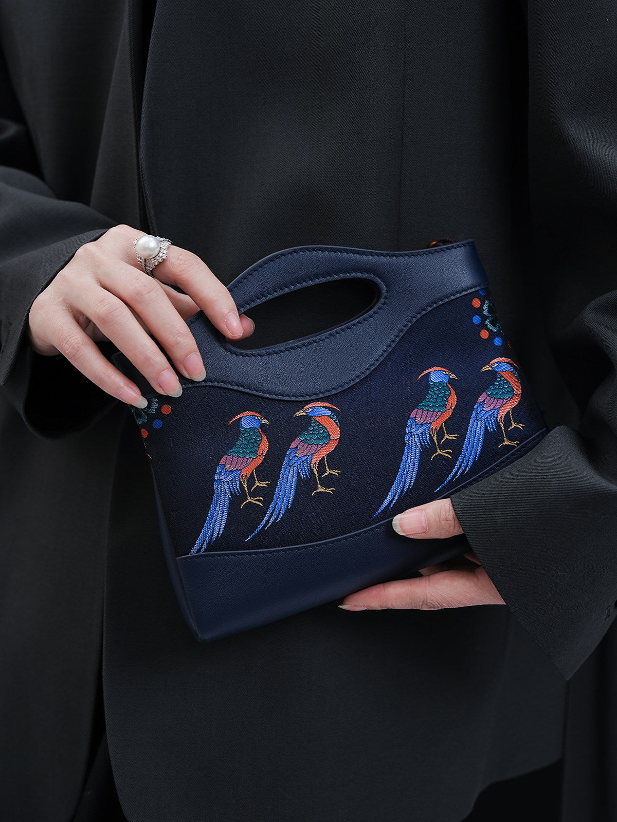 Mulberry silk clutch bag front view with lucky horse motif and refined handbag finish