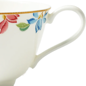Button handle and floral detail of Chinoiserie bone china tea cup.