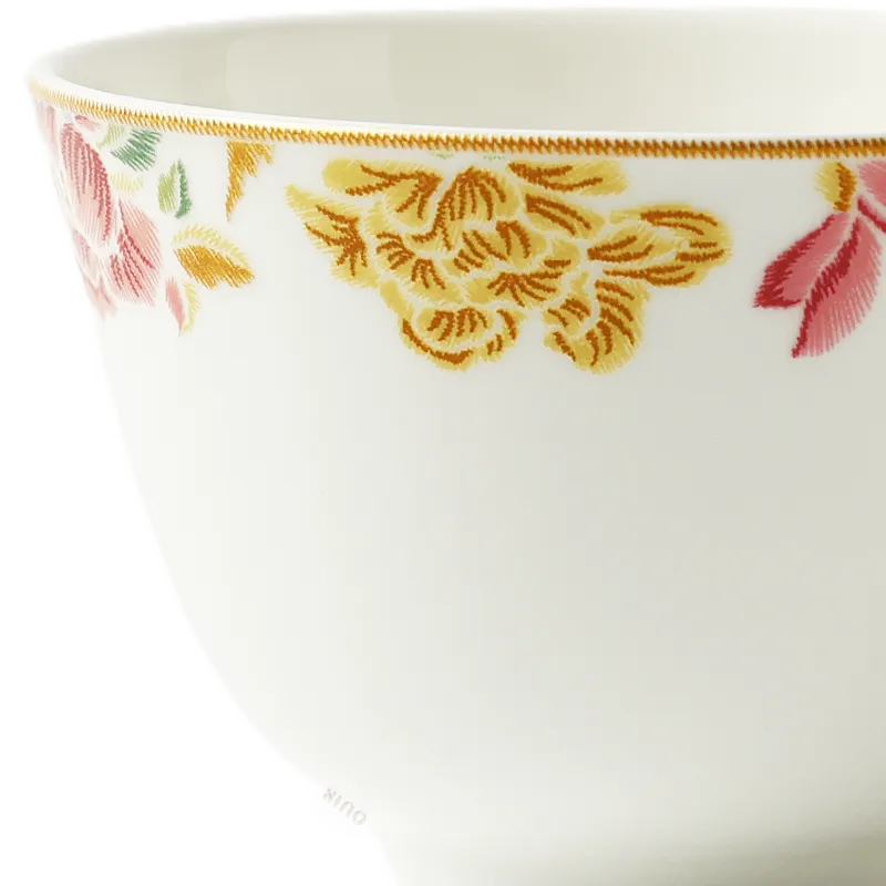 Floral rim detail of Chinoiserie bone china tea cup.