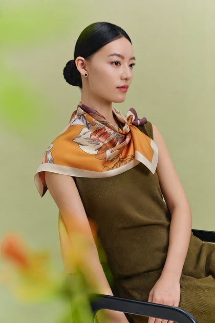 Close view of mulberry silk scarf showing smooth silk texture, color detail, and refined drape