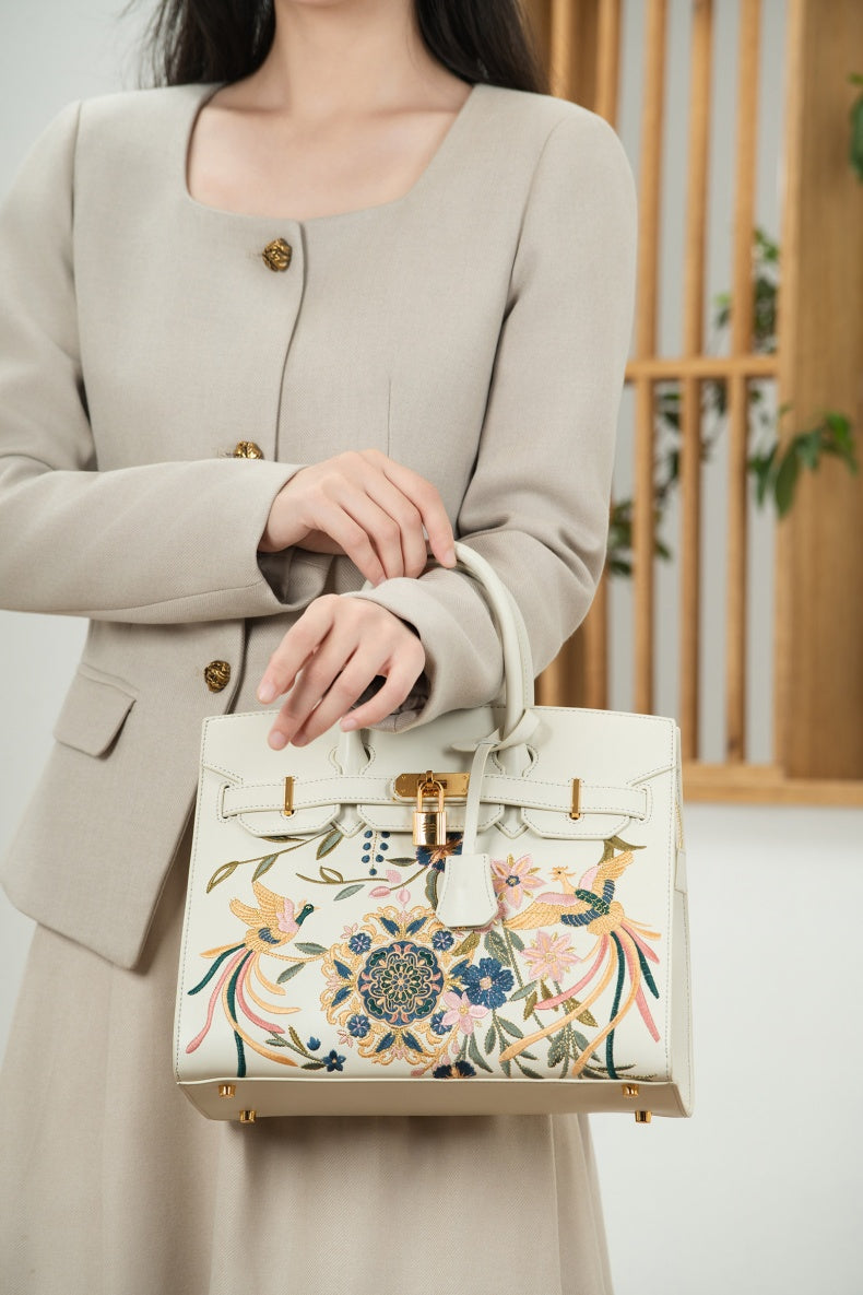 Close view of embroidered crossbody bag showing floral texture and refined leather finish image 7