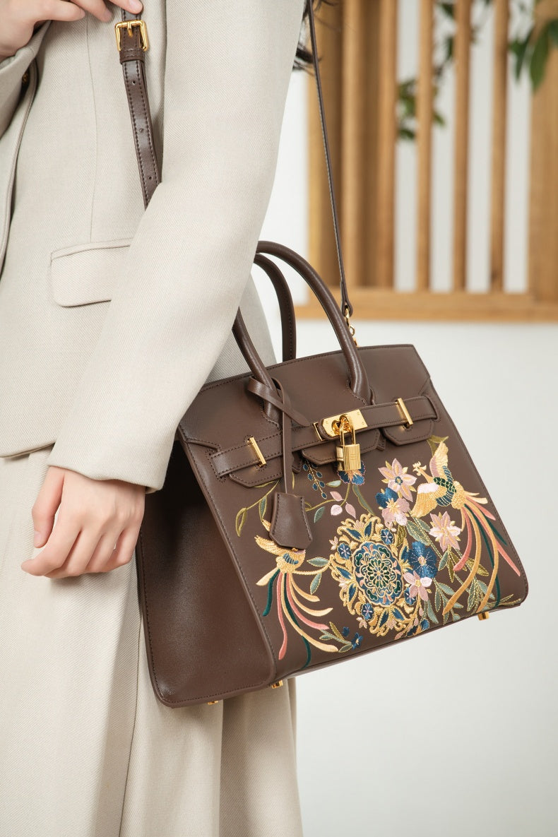Close view of embroidered crossbody bag showing floral texture and refined leather finish image 11