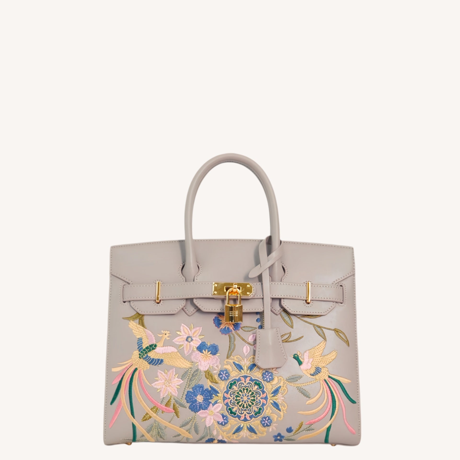 Close view of embroidered crossbody bag showing floral texture and refined leather finish featuring Phoenix & Pear Blossoms