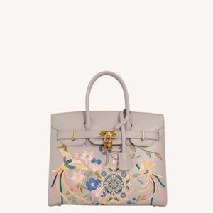 Close view of embroidered crossbody bag showing floral texture and refined leather finish featuring Phoenix & Pear Blossoms