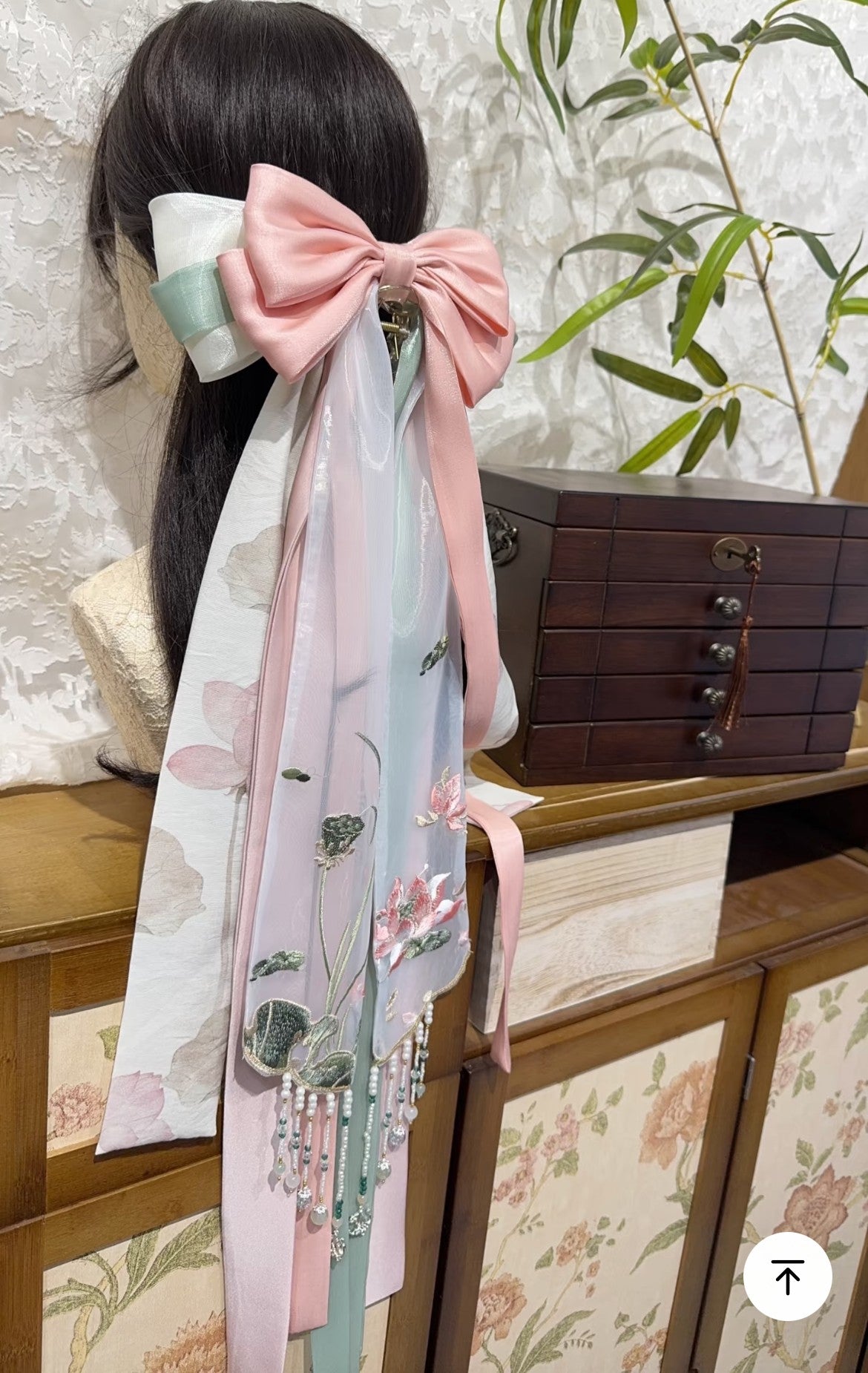 Close view of Moonlit Lotus Pond hair bow with layered ribbon tails and soft floral embroidery