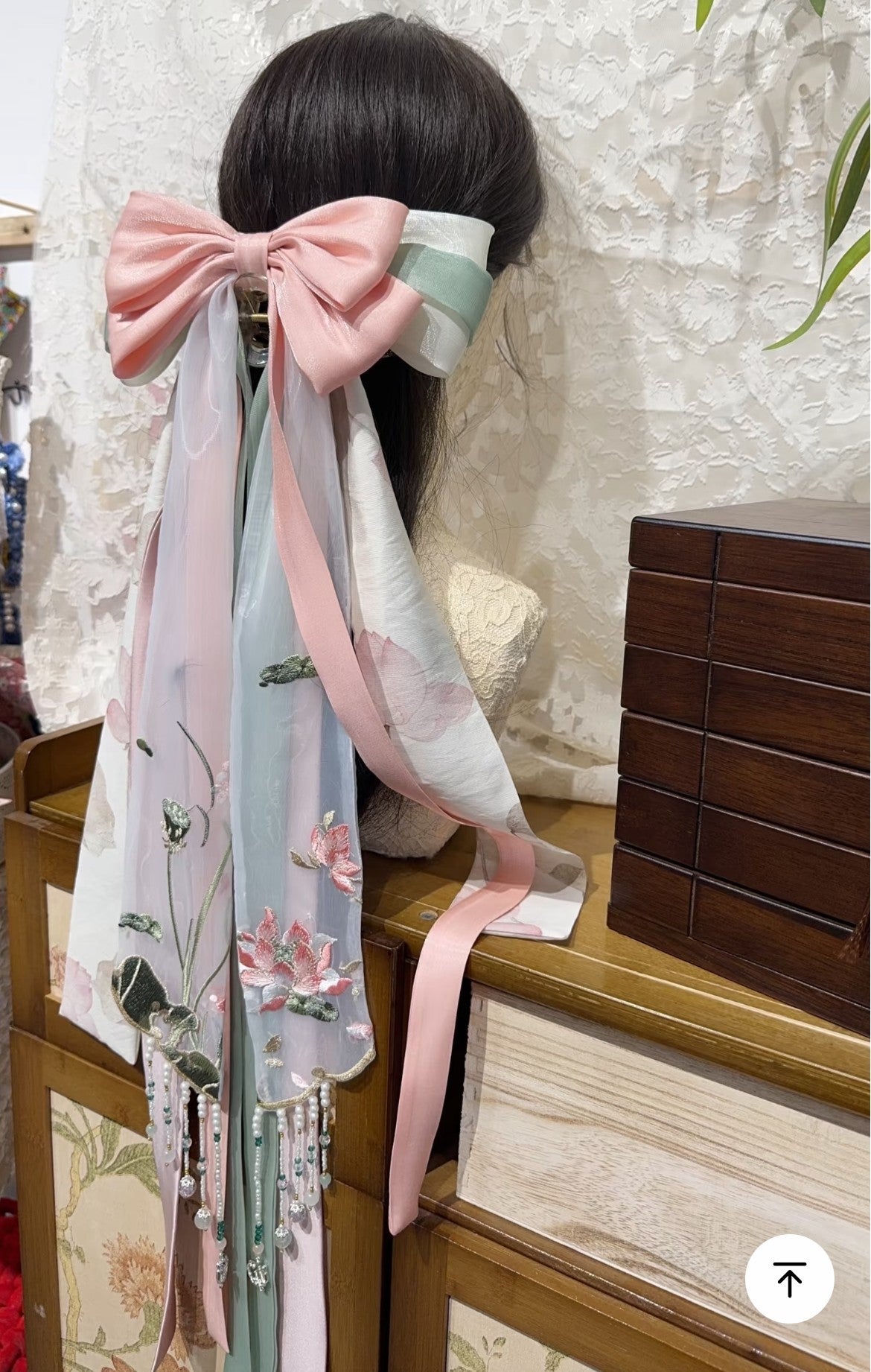 New Chinese lotus hair accessory shown on hair with beaded fringe and graceful ribbon layers