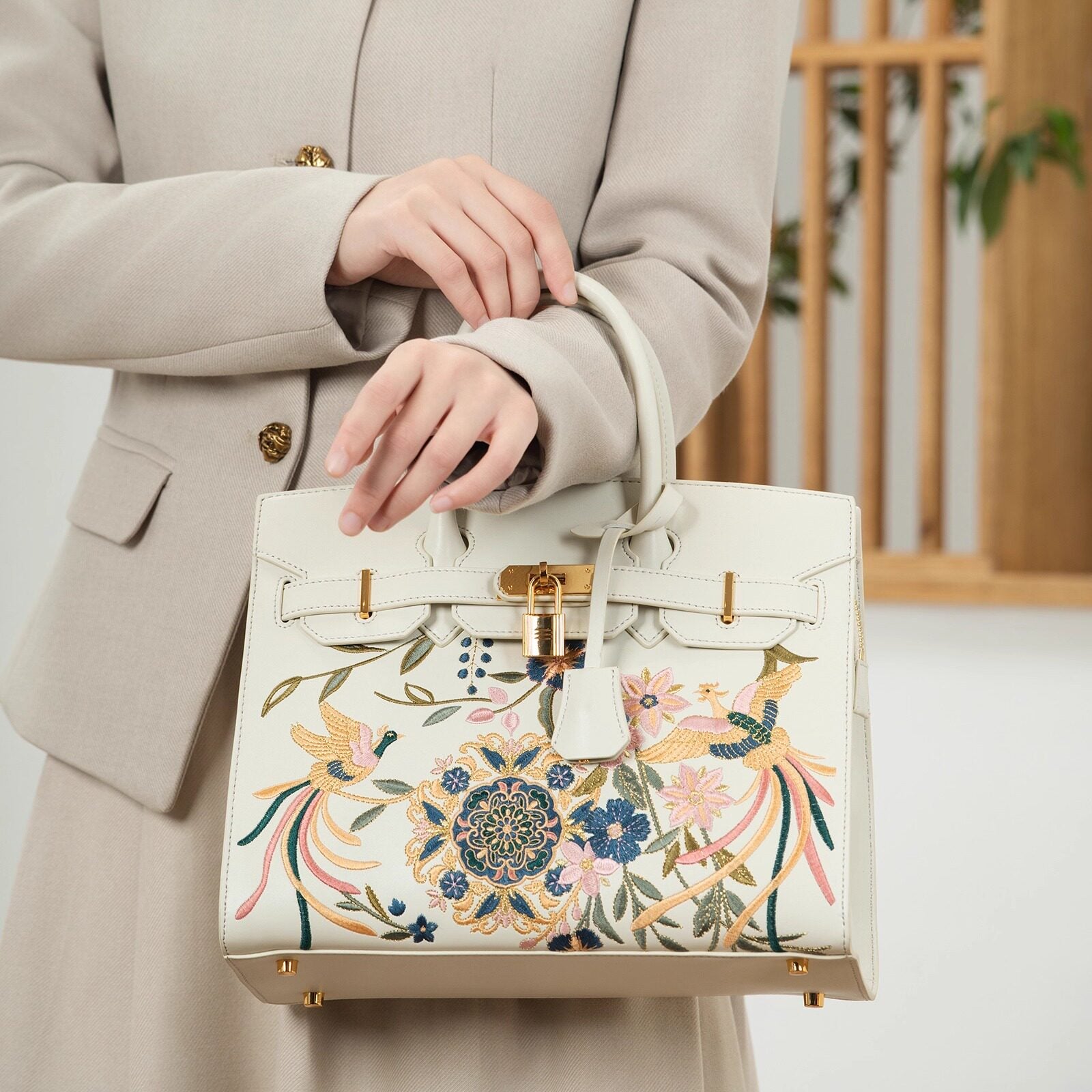 Chinese embroidered crossbody bag front view with phoenix and pear blossom motif and refined handbag finish