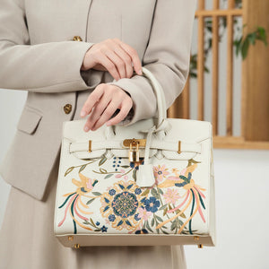 Chinese embroidered crossbody bag front view with phoenix and pear blossom motif and refined handbag finish