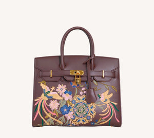 Chinese embroidered crossbody bag three-quarter view with phoenix and pear blossom motif and refined handbag finish