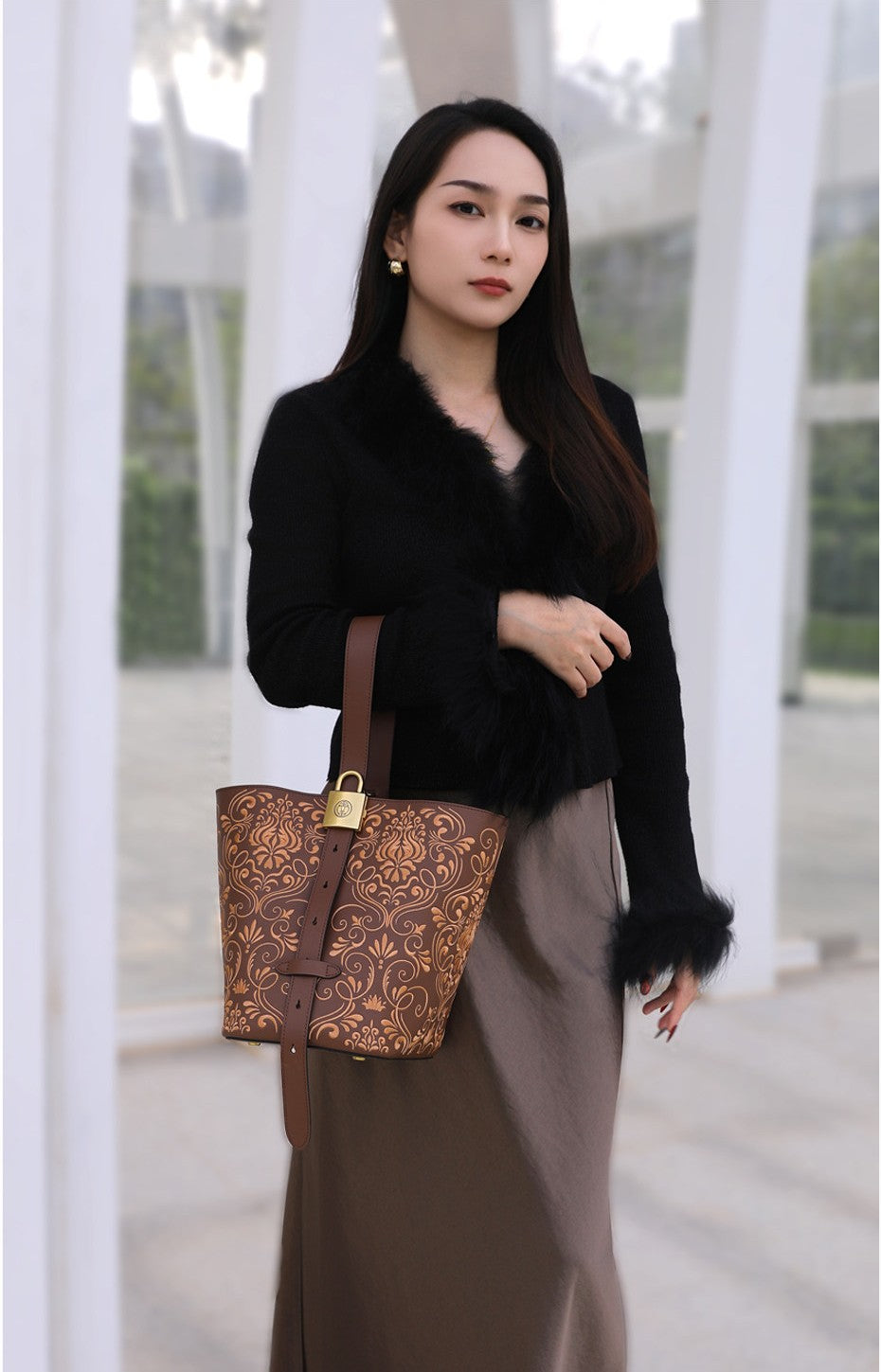 Chinese embroidered bucket bag display view with heritage-inspired motif and refined handbag finish