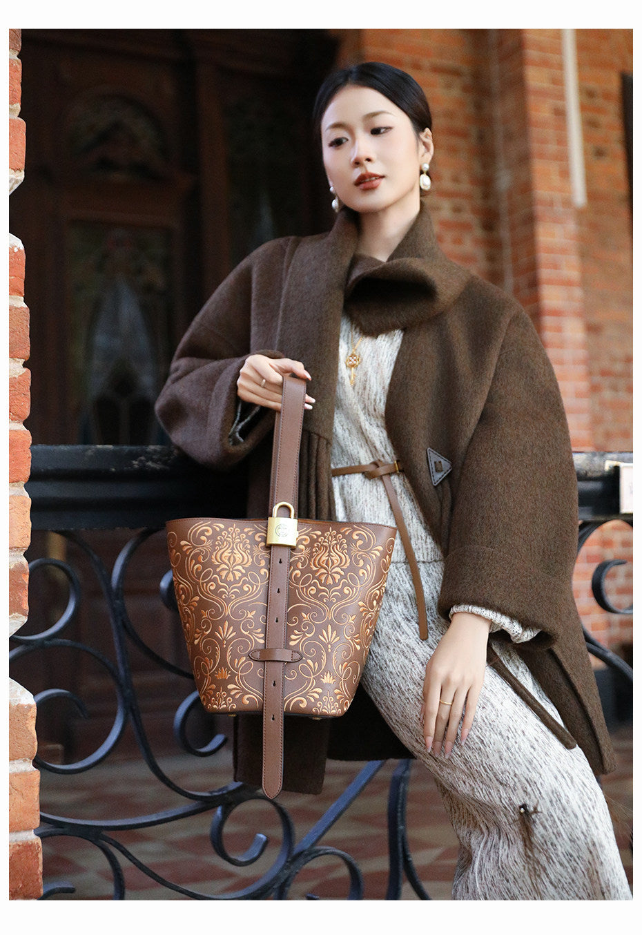 Chinese embroidered bucket bag front view with heritage-inspired motif and refined handbag finish