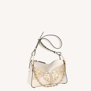 Close view of embroidered crossbody bag showing floral texture and refined leather finish featuring Embroidered-brocademodern