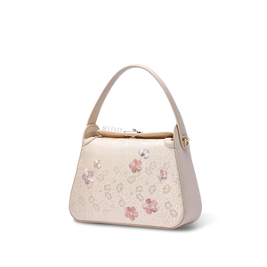 Side profile of luxury plum blossom silk handbag.