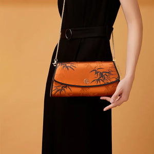 Model Crossbodying Vintage Chinoiserie Bamboo Clutch with Black Qipao.