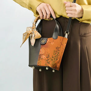Model carrying embroidered handbag crossbody style.