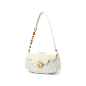 Profile of luxury white brocade shoulder bag showing depth.
