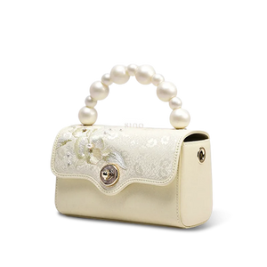 Side profile of luxury silk handbag showing depth.