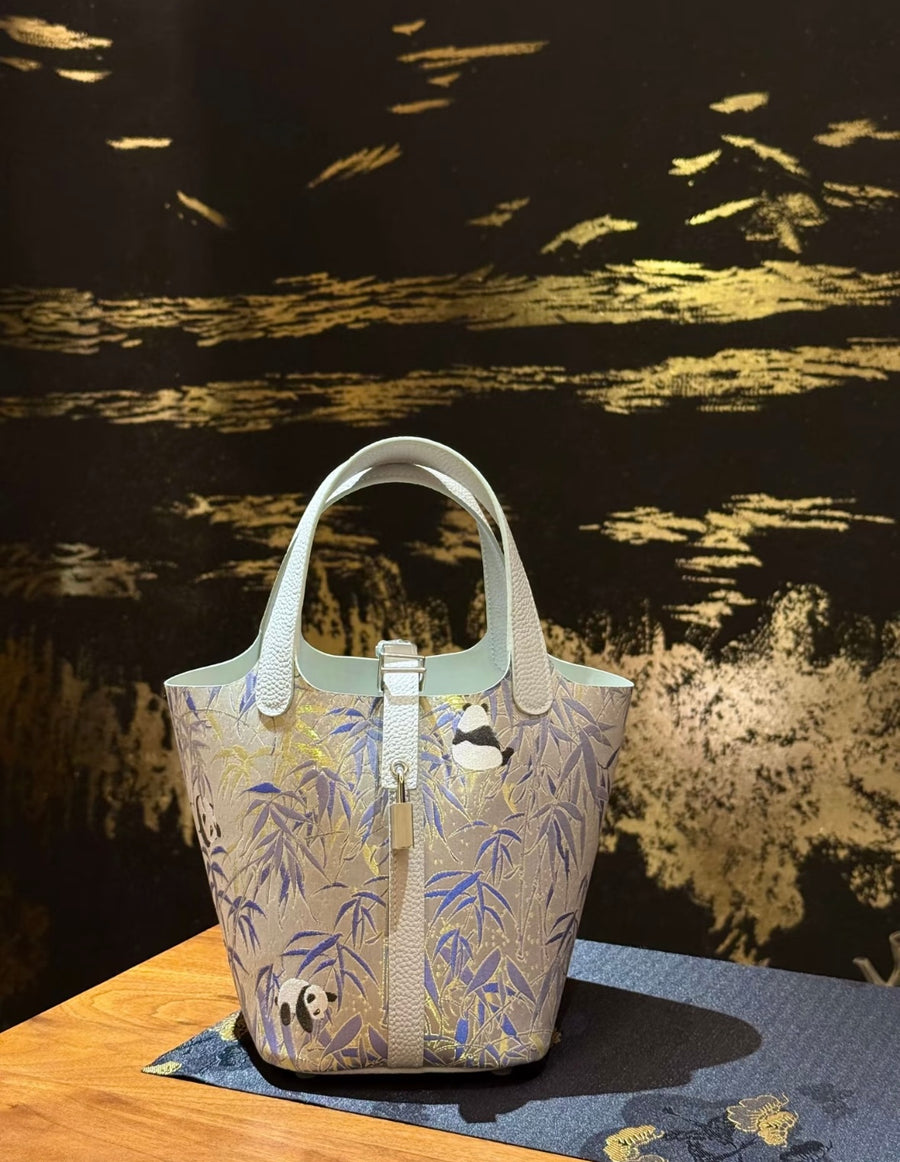 Panda Bamboo Chinese Song Brocade handbag with white leather handles, blue bamboo motifs, and playful panda details brocademodern