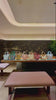 Brocade Modern Chinese Song Brocade handbags displayed in a refined interior, featuring blue, green, gold, pink, ivory, and red brocade top-handle bags with leather handles.